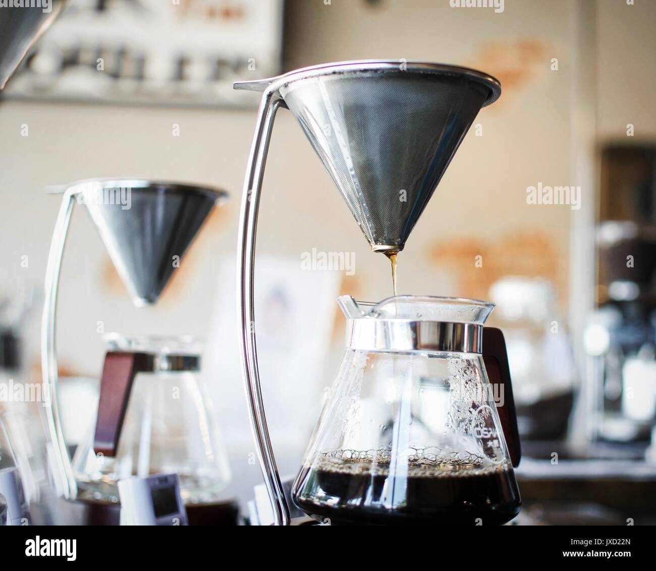 Pour over coffee stand dripping over glass carafe decanter Stock Photo