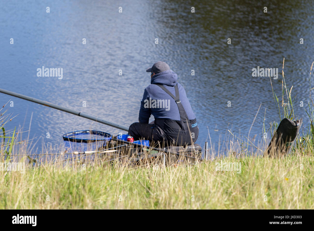 Anglers fishing at a Mill Pond in The Lancashire Hills Stock Photo