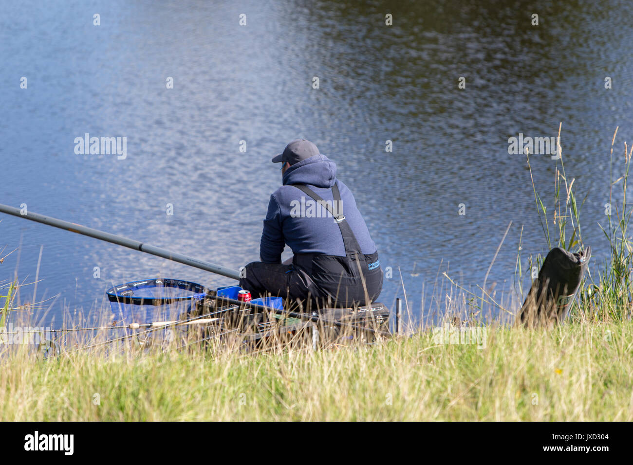 Anglers fishing at a Mill Pond in The Lancashire Hills Stock Photo