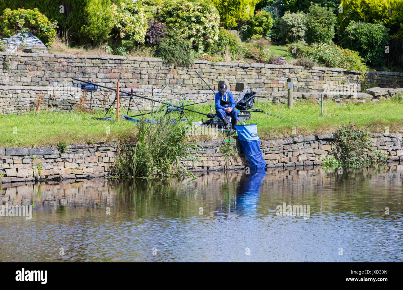 Anglers fishing at a Mill Pond in The Lancashire Hills Stock Photo