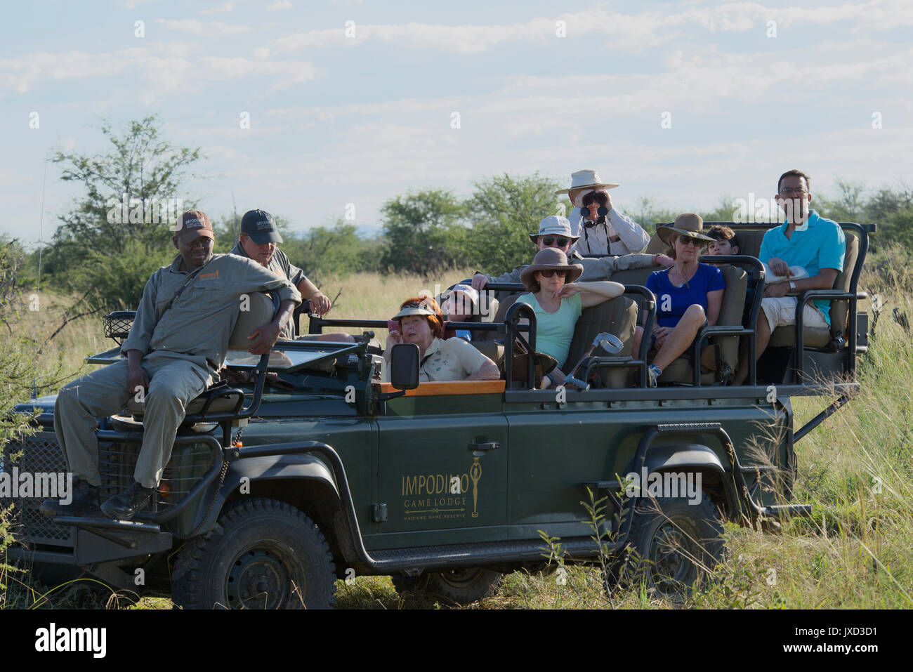 People in game viewing vehicle Madikwe Game Reserve South Africa Stock Photo