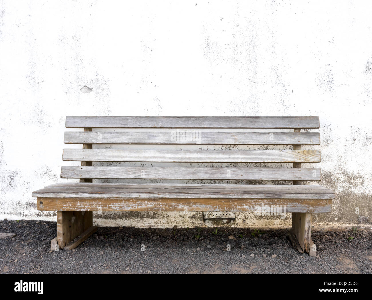 Wooden Bench Against Whitewashed Wall in public park space Stock Photo ...