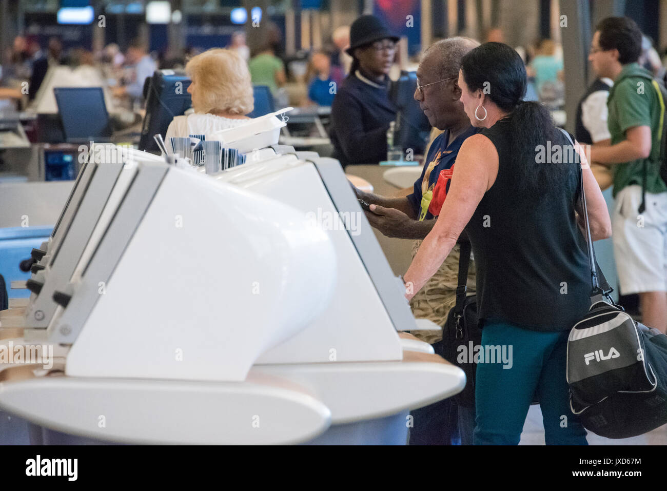 Traveling seniors at Delta Air Lines self check-in kiosk at Hartsfiled-Jackson Atlanta International Airport in Atlanta, Georgia, USA. Stock Photo