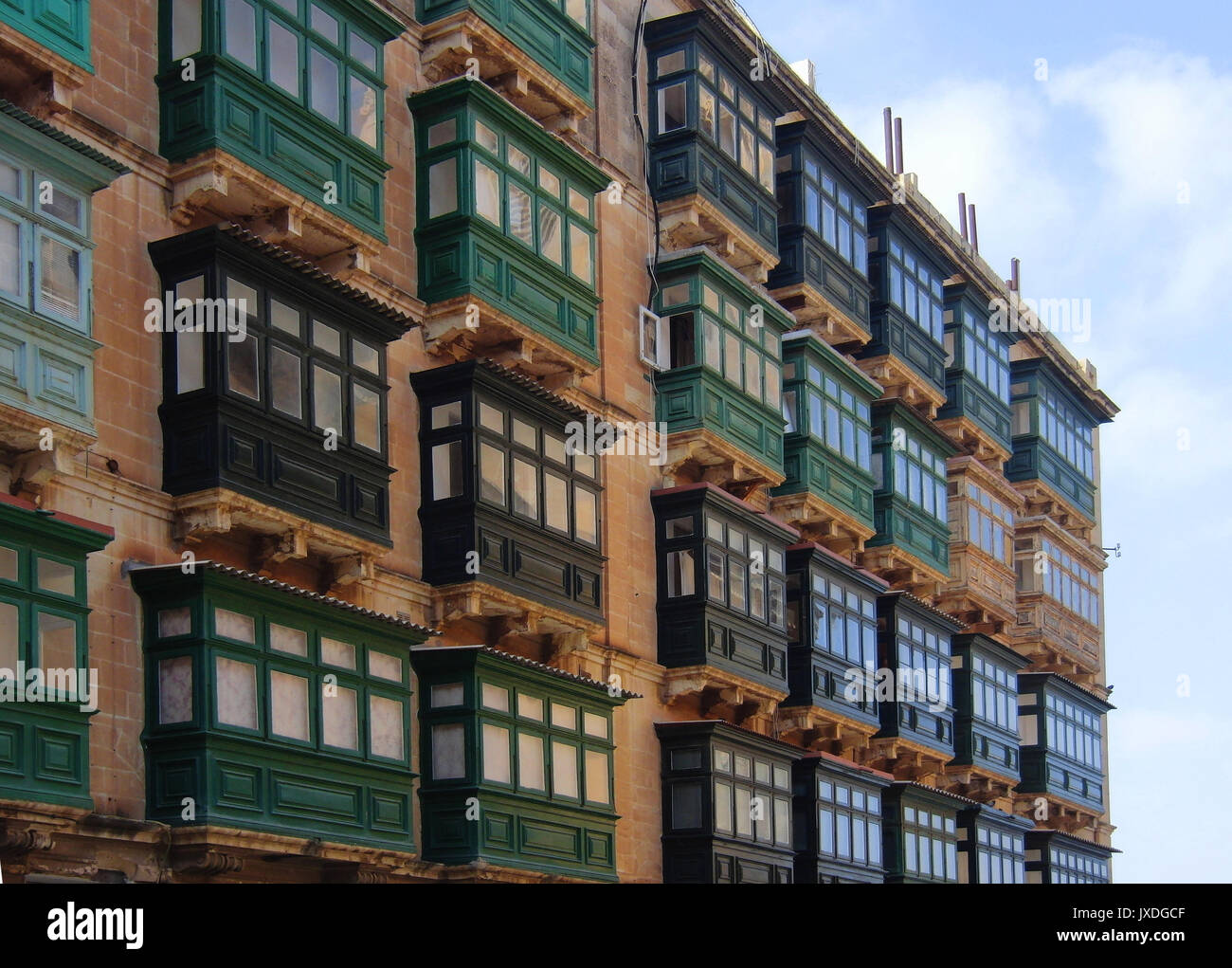 Famous Valletta building with many green balconies each similar but each slightly different. Stock Photo