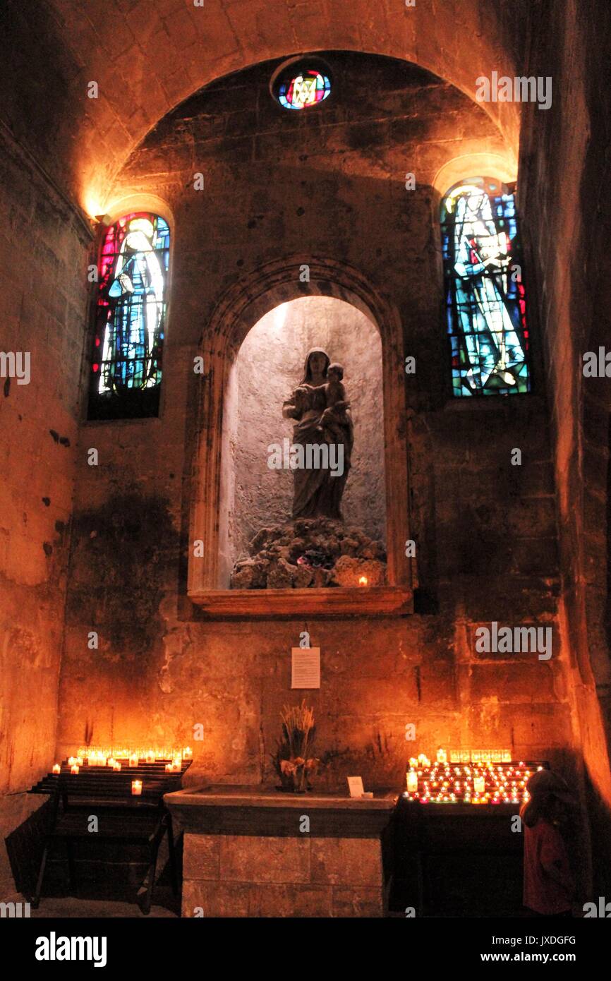 Maltese Church chapel with candles statue and glass warm lighting Stock