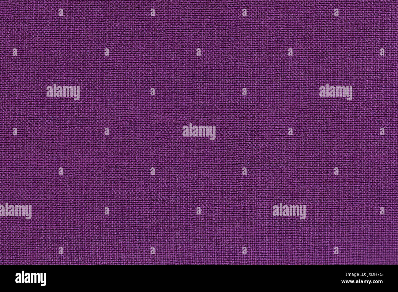 Dark violet background from a textile material with wicker pattern, closeup. Structure of the purple fabric with natural texture. Cloth backdrop. Stock Photo