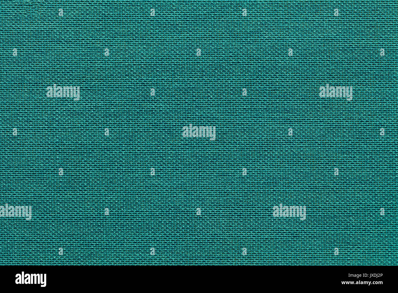 Light turquoise background from a textile material with wicker pattern, closeup. Structure of the emerald fabric with natural texture. Cloth backdrop. Stock Photo