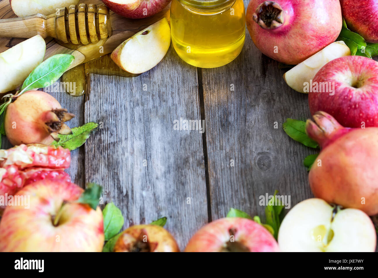 Apples, pomegranate and honey - symbols of judaic holiday Rosh Hashana (Jewish New Year). Selective focus. Copyspace background. Stock Photo