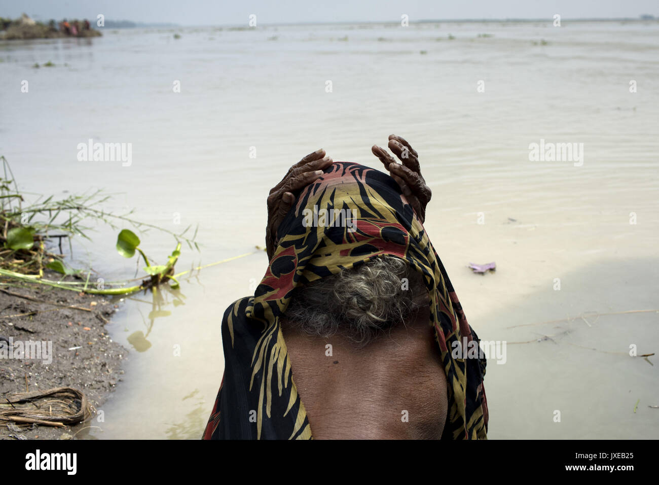 Dhaka, Bangladesh. 15th Aug, 2017. Old women sit in the site of Jamuna river when all area under the floodwater at Sariakandhi. Flood-related incidents in Dinajpur, Gaibandha and Lalmonirhat raising the death toll to 30 in the last three days across the country. Credit: K M Asad/ZUMA Wire/Alamy Live News Stock Photo