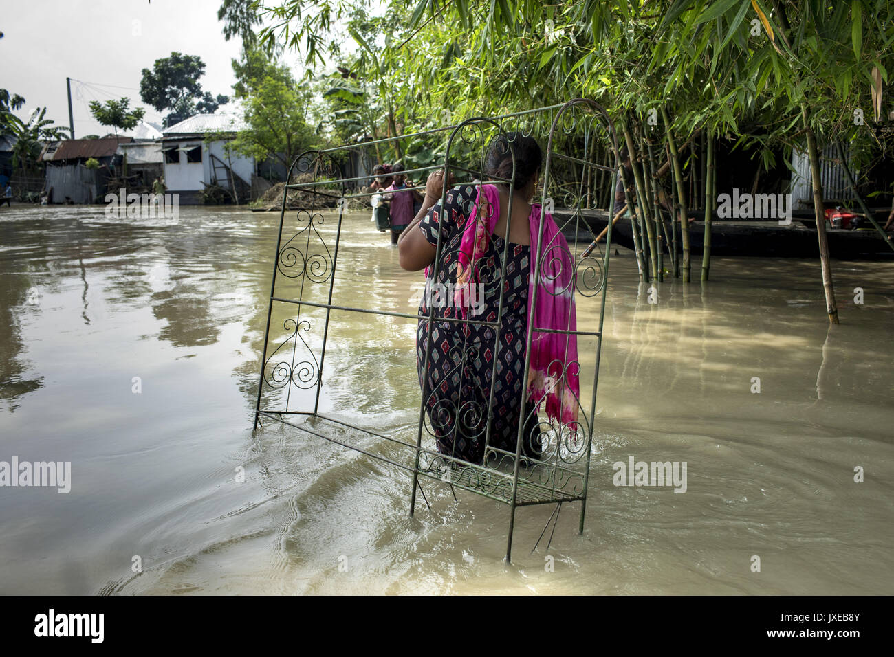 Dhaka, Bangladesh. 15th Aug, 2017. Woman with her belonging move other place when all area under the floodwater at Sariakandhi. Flood-related incidents in Dinajpur, Gaibandha and Lalmonirhat raising the death toll to 30 in the last three days across the country. Credit: K M Asad/ZUMA Wire/Alamy Live News Stock Photo
