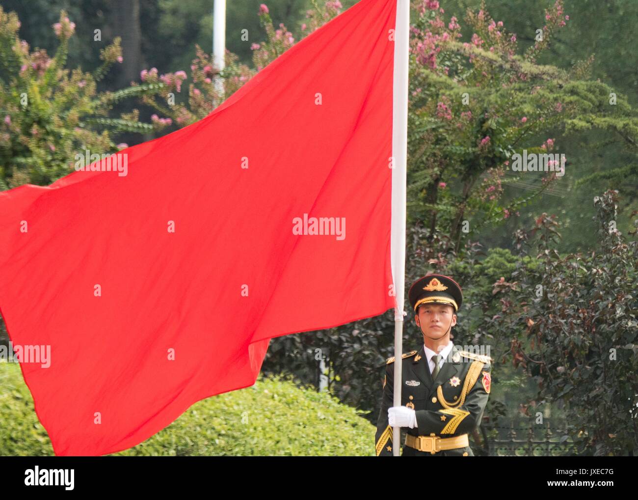 Beijing, China. 15th Aug, 2017. Chinese People's Liberation Army honor guard hold a red flag during a the arrival ceremony for U.S. Chairman of the Joint Chiefs Gen. Joseph Dunford at the Bayi building August 15, 2017 in Beijing, China. Dunford is in Beijing to strengthen communication between the two militaries amid tensions concerning North Korea. Credit: Planetpix/Alamy Live News Stock Photo