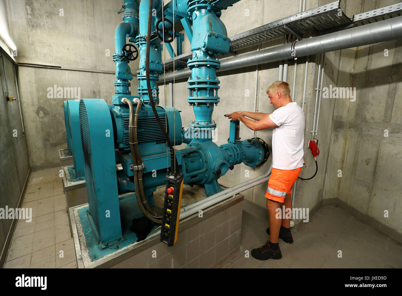 Schweinfurt, Germany. 17th July, 2017. The sewage worker Kai Zinser stands in front of a unit of the underground rain overflow basin in the city centre of Schweinfurt, Germany, 17 July 2017. Unnoticed by many people sewage workers take care that cities do not turn into stinking cesspools. A great amount of the daytime they, therefore, spend in the underground. Photo: Daniel Karmann/dpa/Alamy Live News Stock Photo