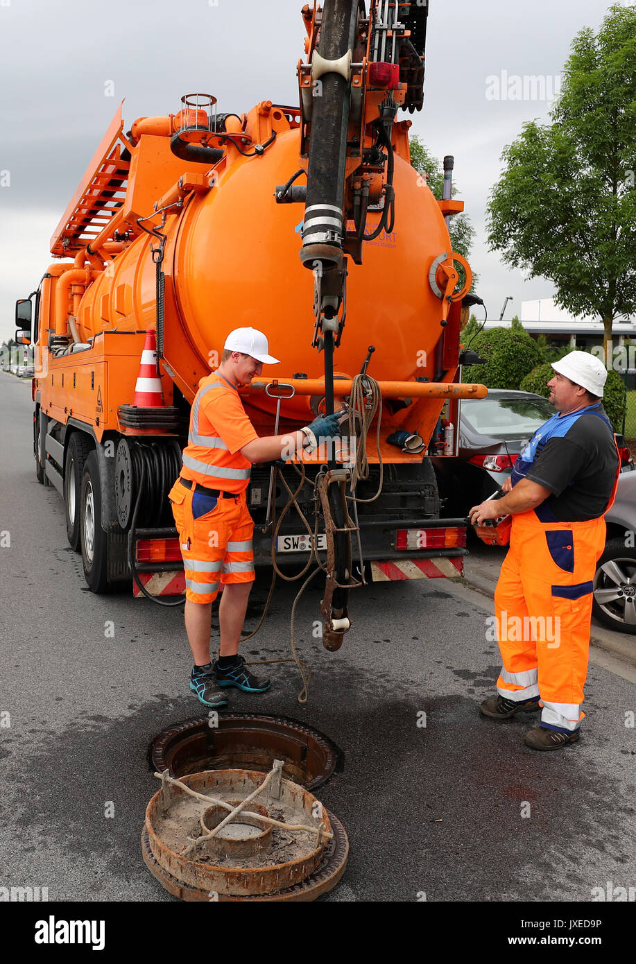 Schweinfurt, Germany. 17th July, 2017. Employees of the municipal drainage operation Schweinfurt pull a high-pressure cleaner into the underground sewerage in Schweinfurt, Germany, 17 July 2017. Unnoticed by many people sewage workers take care that cities do not turn into stinking cesspools. A great amount of the daytime they, therefore, spend in the underground. Photo: Daniel Karmann/dpa/Alamy Live News Stock Photo