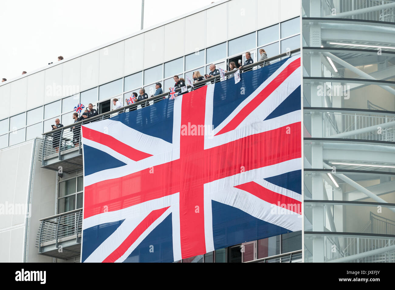 A large union jack flag hanging on the Ben Ainslie Racing HQ building in Old Portsmouth, Hampshire, England. The flag was hung to celebrate the arrival of HMS Queen Elizabeth into Portsmouth Harbour. Stock Photo