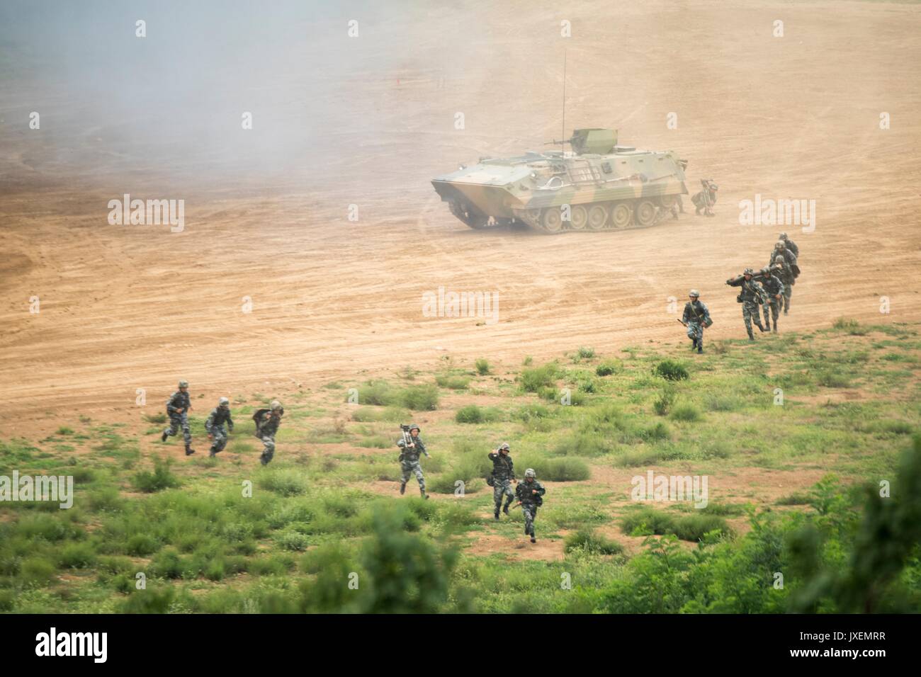 Haichung, China. 16th Aug, 2017. People's Liberation Army soldiers deploy with anti-tank weapons from a WZ531 armored personal carrier during an attack exercise at the Chinese Northern Theater Command Army Force Haichung Camp August 16, 2017 in Haichung, China. The exercise was for visiting U.S. Chairman of the Joint Chiefs Gen. Joseph Dunford. Credit: Planetpix/Alamy Live News Stock Photo