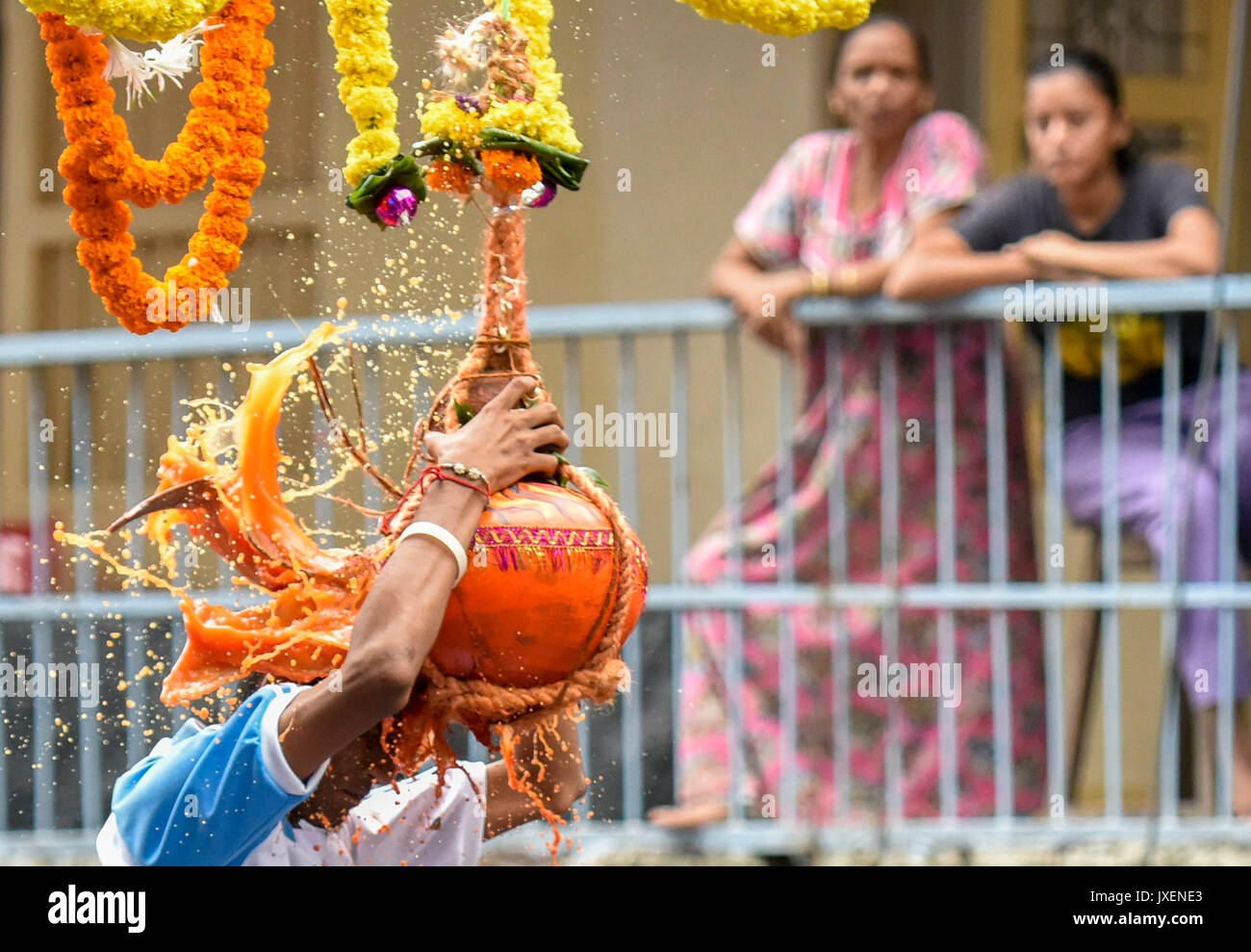 MUMBAI, INDIA - AUGUST 15: A Govinda break the Dahi handi an earthen pot  filled with curd hanging above them, as part of celebrations to mark the  Janmashtami festival at Dadar on
