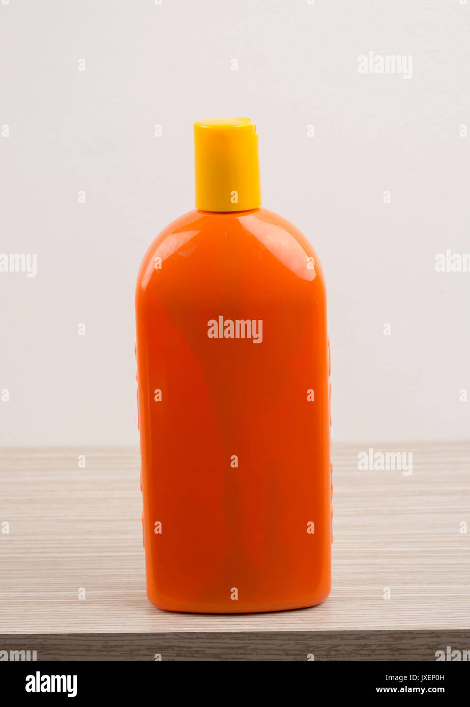 Plastic orange no name shampoo container. Stock Photo