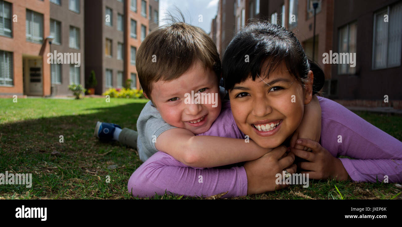 Portrait of kids lying on the grass. Stock Photo