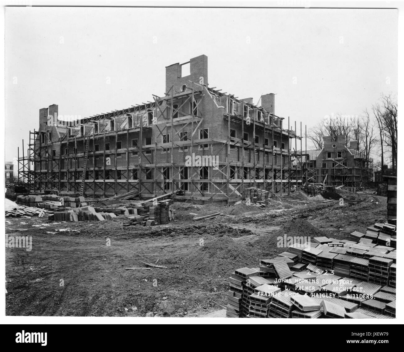 Alumni Memorial Residences Looking southeast, Scaffolding is placed around the AMR exterior, Piles of building material in construction lot, Tiles have not been placed on mansard roof, 1923. Stock Photo