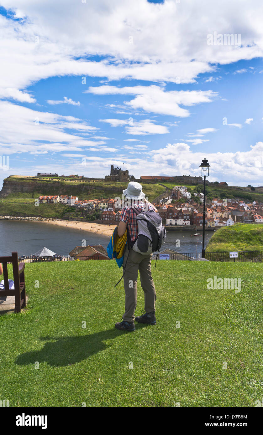 dh West Cliff town harbour WHITBY NORTH YORKSHIRE Tourist woman overlooking abbey england sightseer holidaymaker sightseeing britain Stock Photo