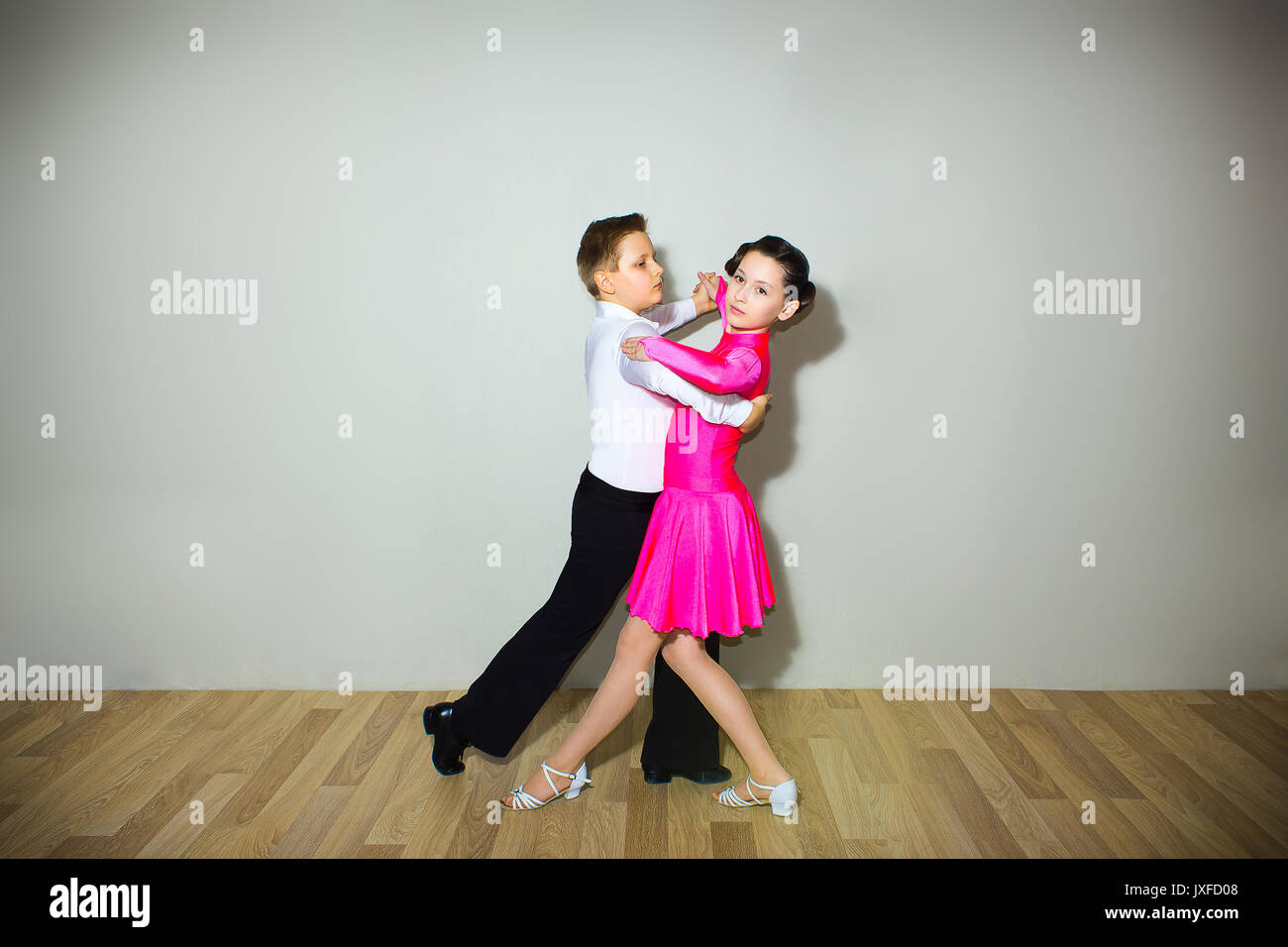 The young boy and girl posing at dance studio Stock Photo
