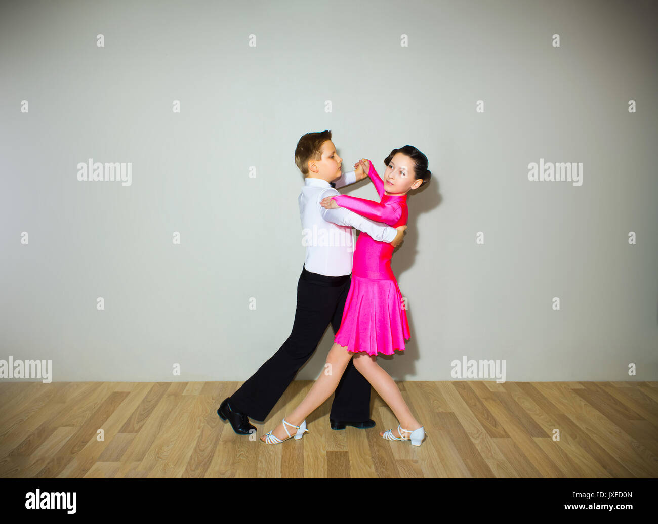 The young boy and girl posing at dance studio Stock Photo Alamy