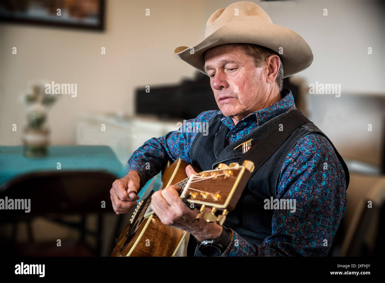 Western cowboy playing guitar Stock Photo