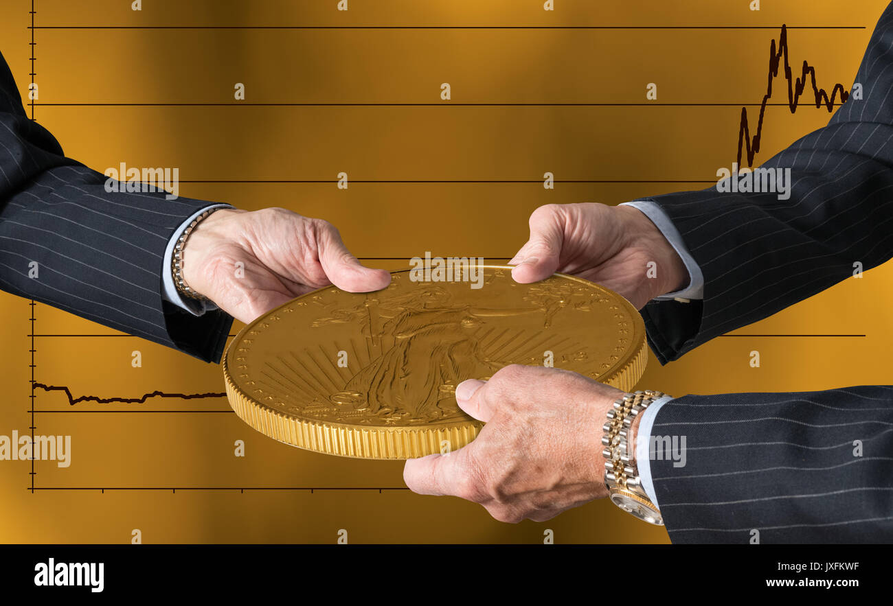 Three traders hands holding large gold coin Stock Photo
