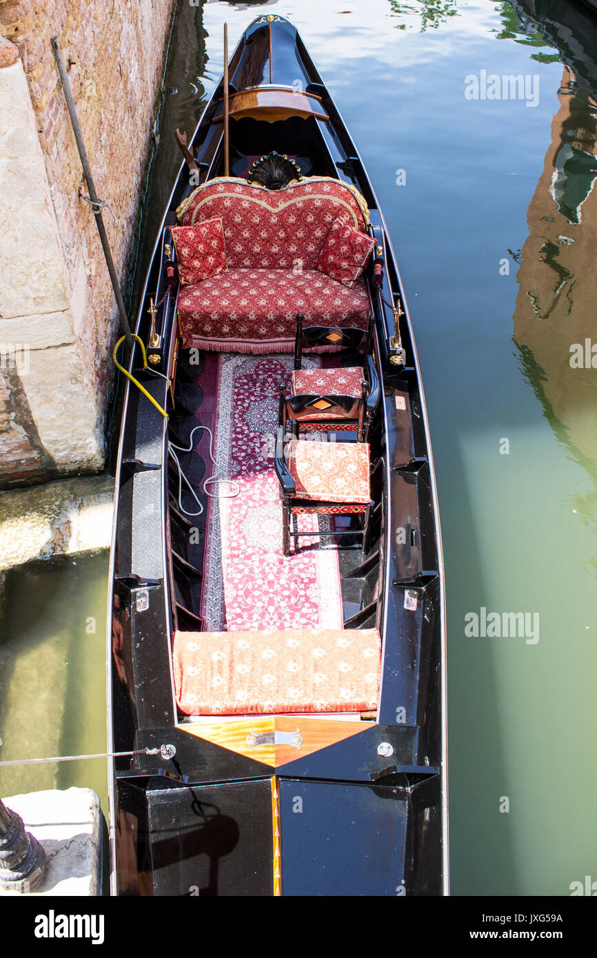 A parked gondola in a venetian channel Stock Photo