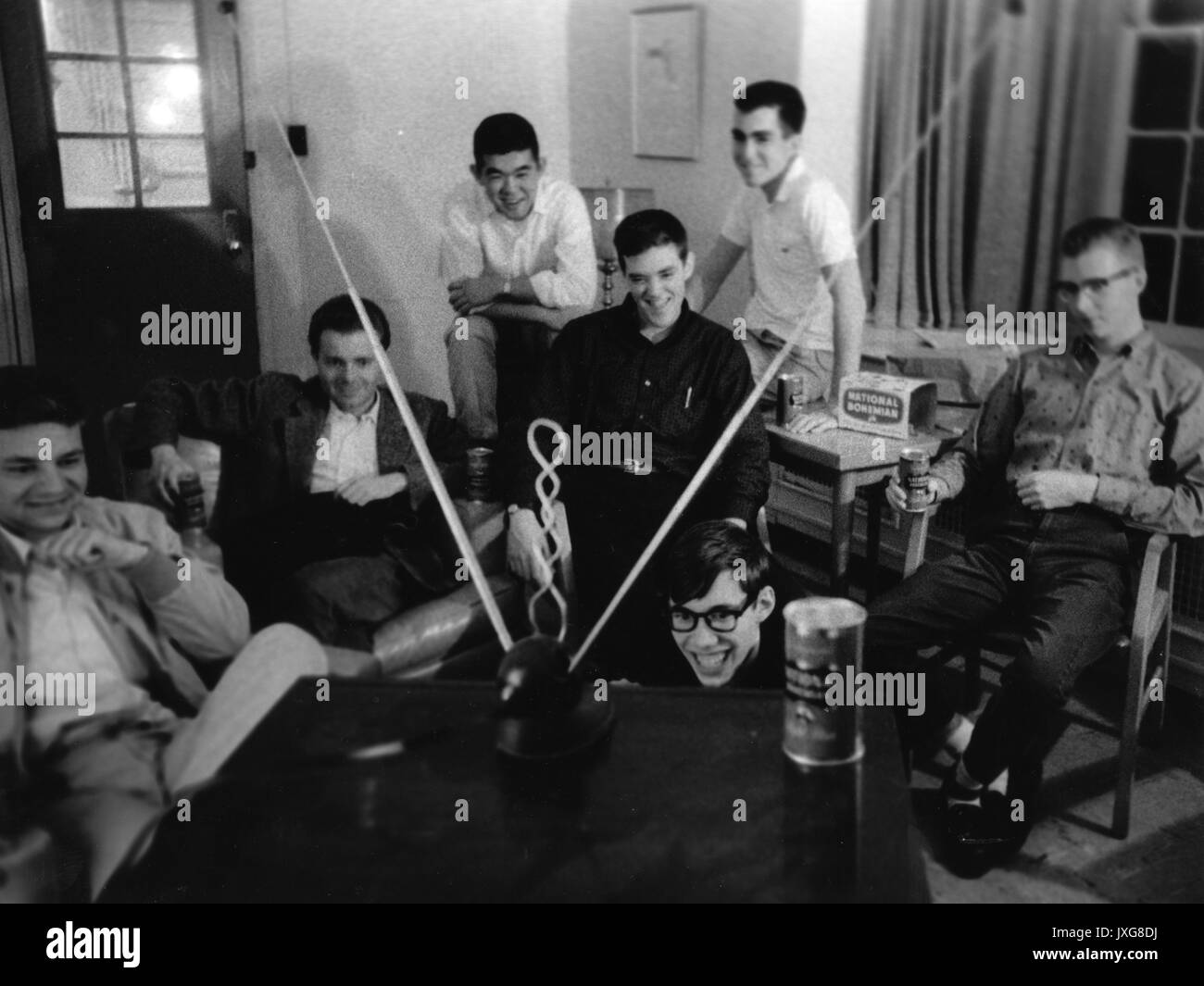 Student Life, Fraternities Students are relaxing, drinking beer, and watching television in a fraternity house, 1960. Stock Photo