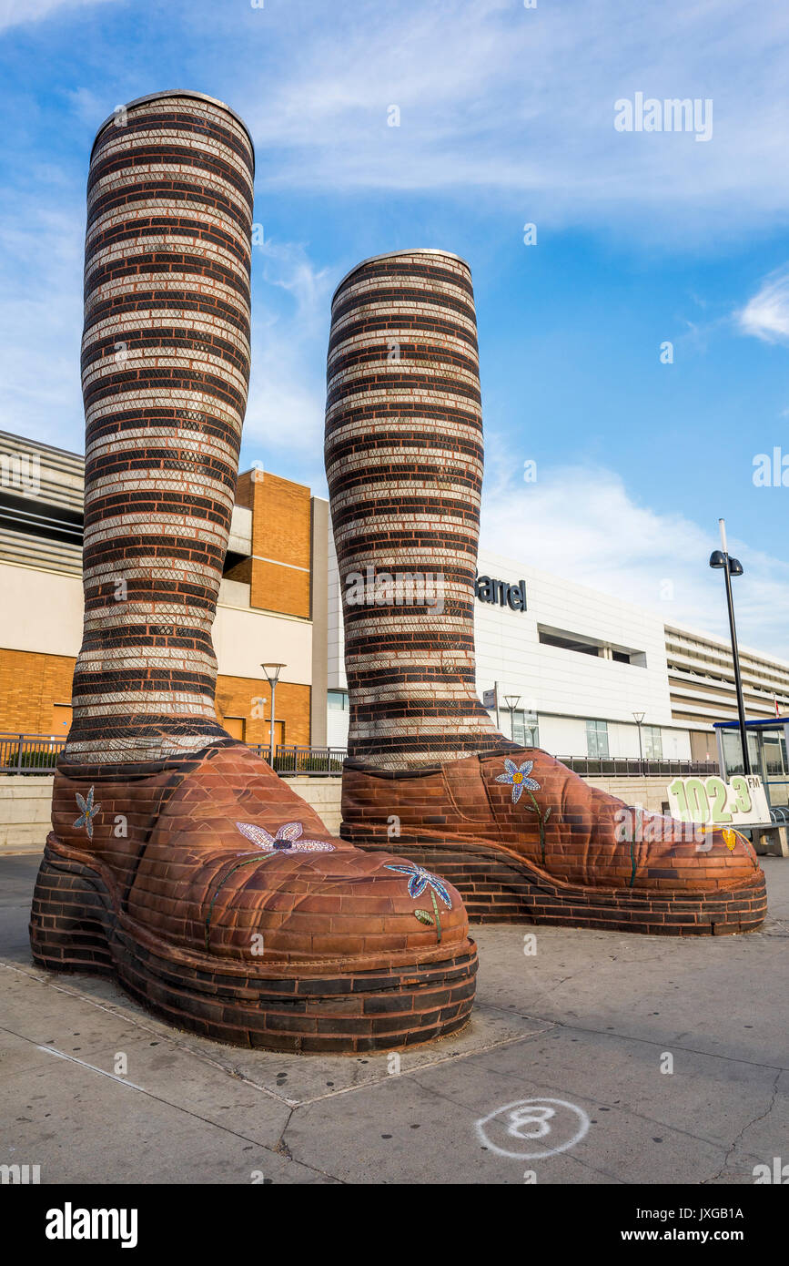 Giant ceramic leg and boot sculpture called 'Immense Mode' at Southgate Transit Centre, Edmonton, Alberta, Canada Stock Photo