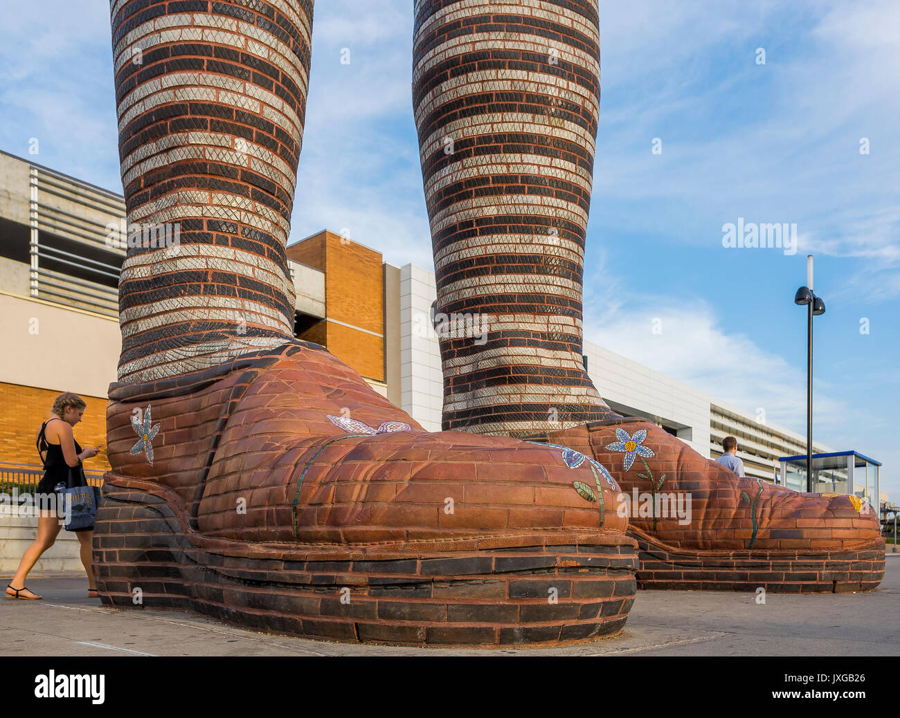 Giant ceramic leg and boot sculpture called 'Immense Mode' at Southgate Transit Centre, Edmonton, Alberta, Canada Stock Photo