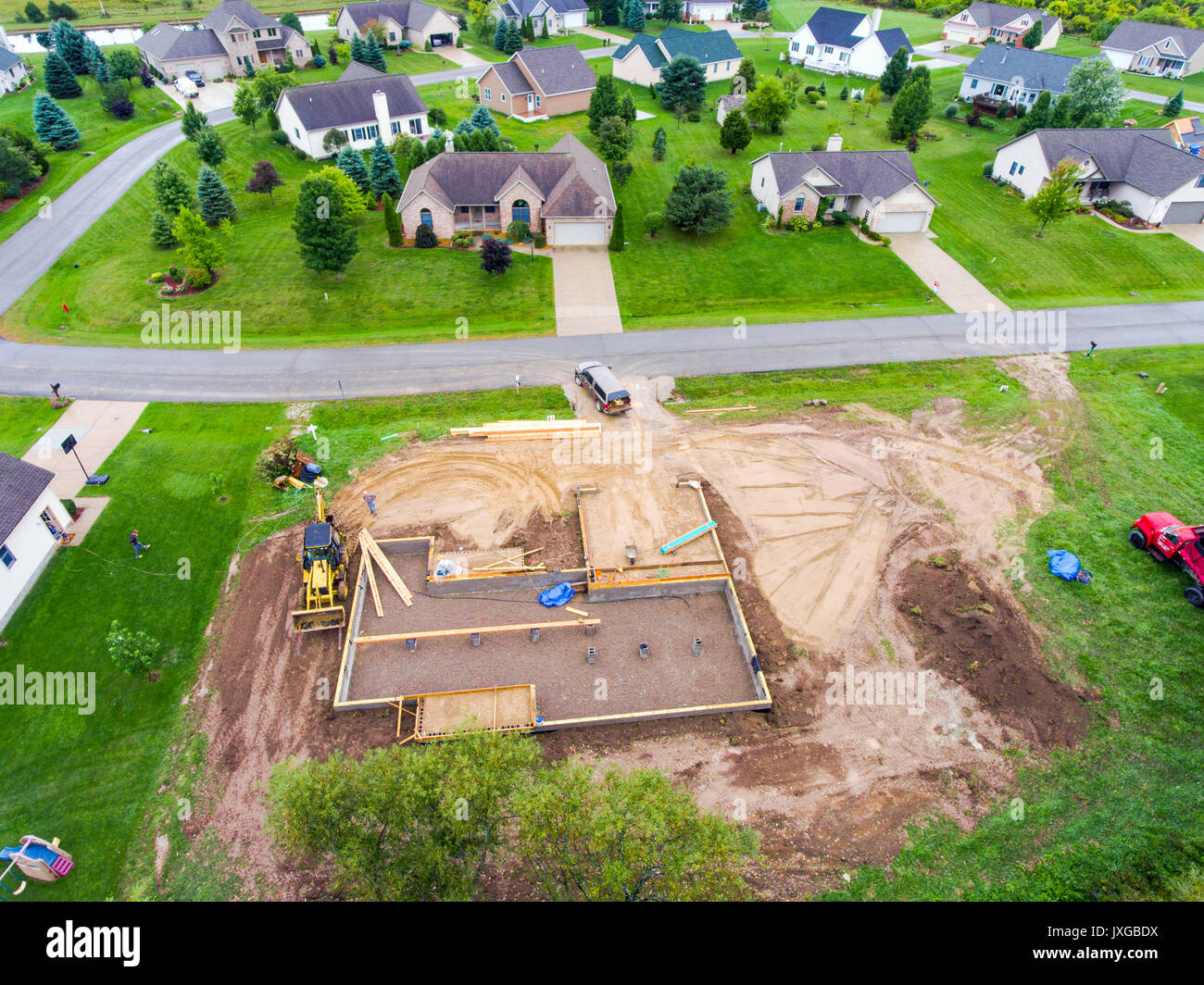 The foundation of a new home house construction in a residential neighborhood aerial view Stock Photo