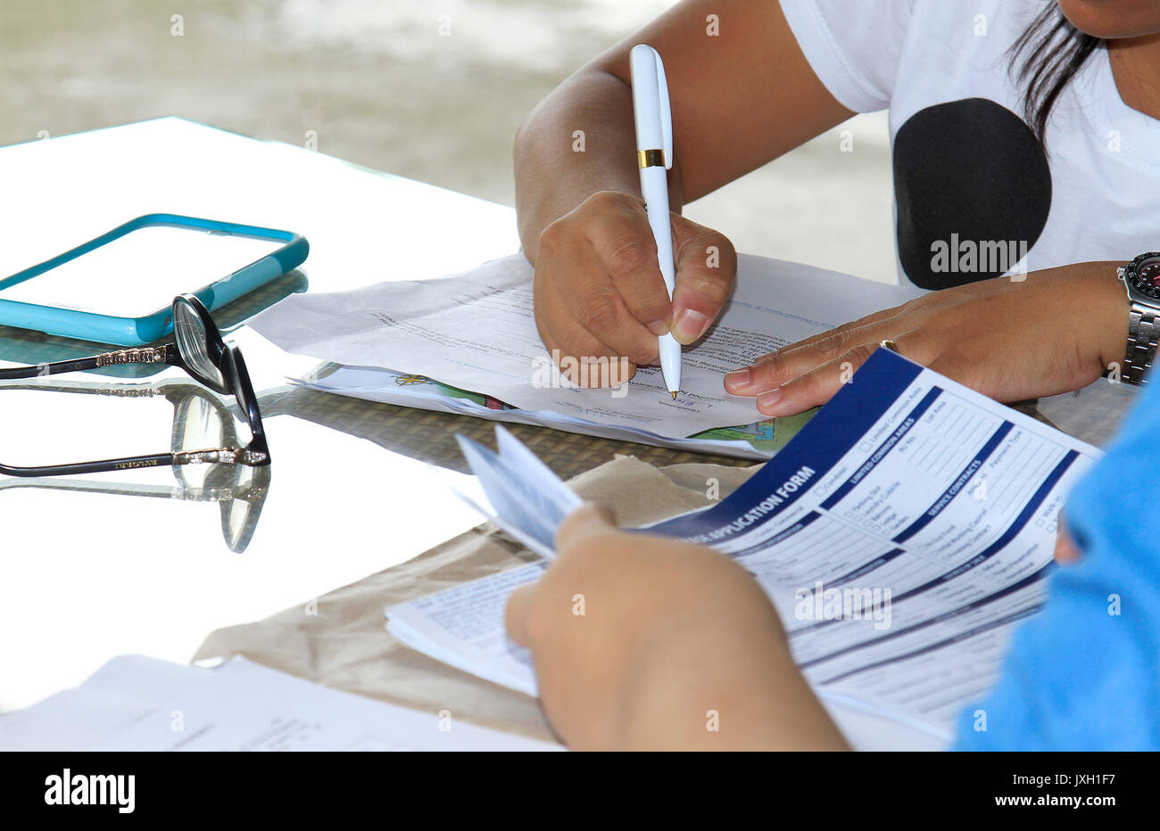 Close up of an executive hands holding a pen and indicating where to ...