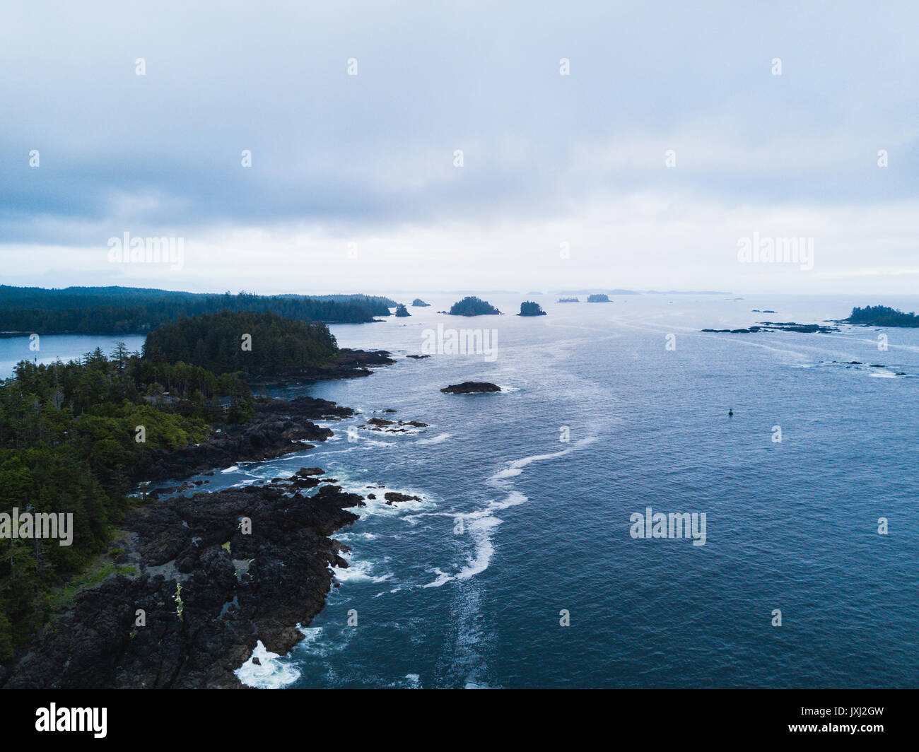Remote ocean shore in cloudly weather and islands on coast Stock Photo