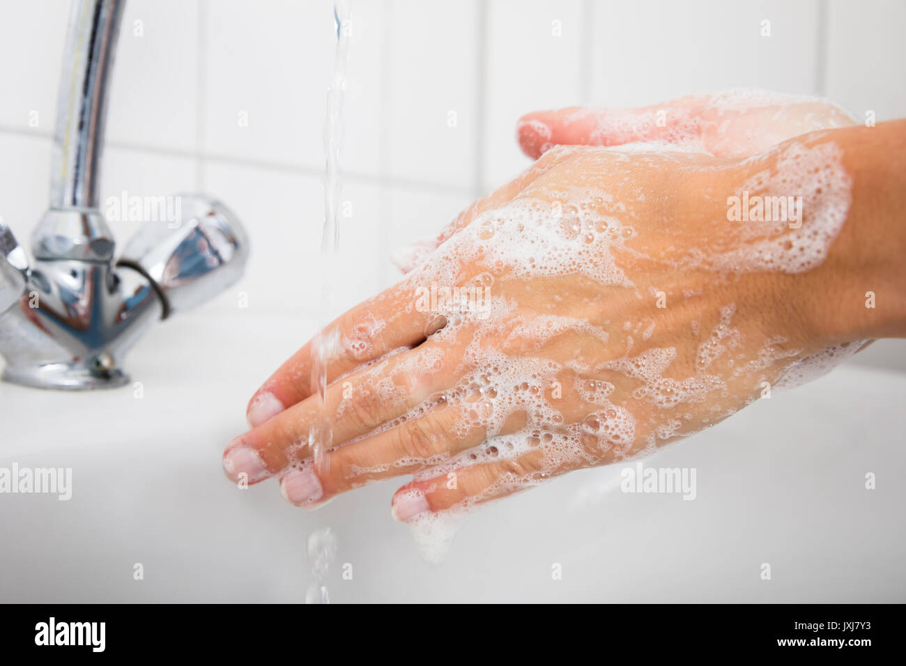 Close-up Of Woman Washing Hands In The Basin After Cleaning The Room Stock Photo