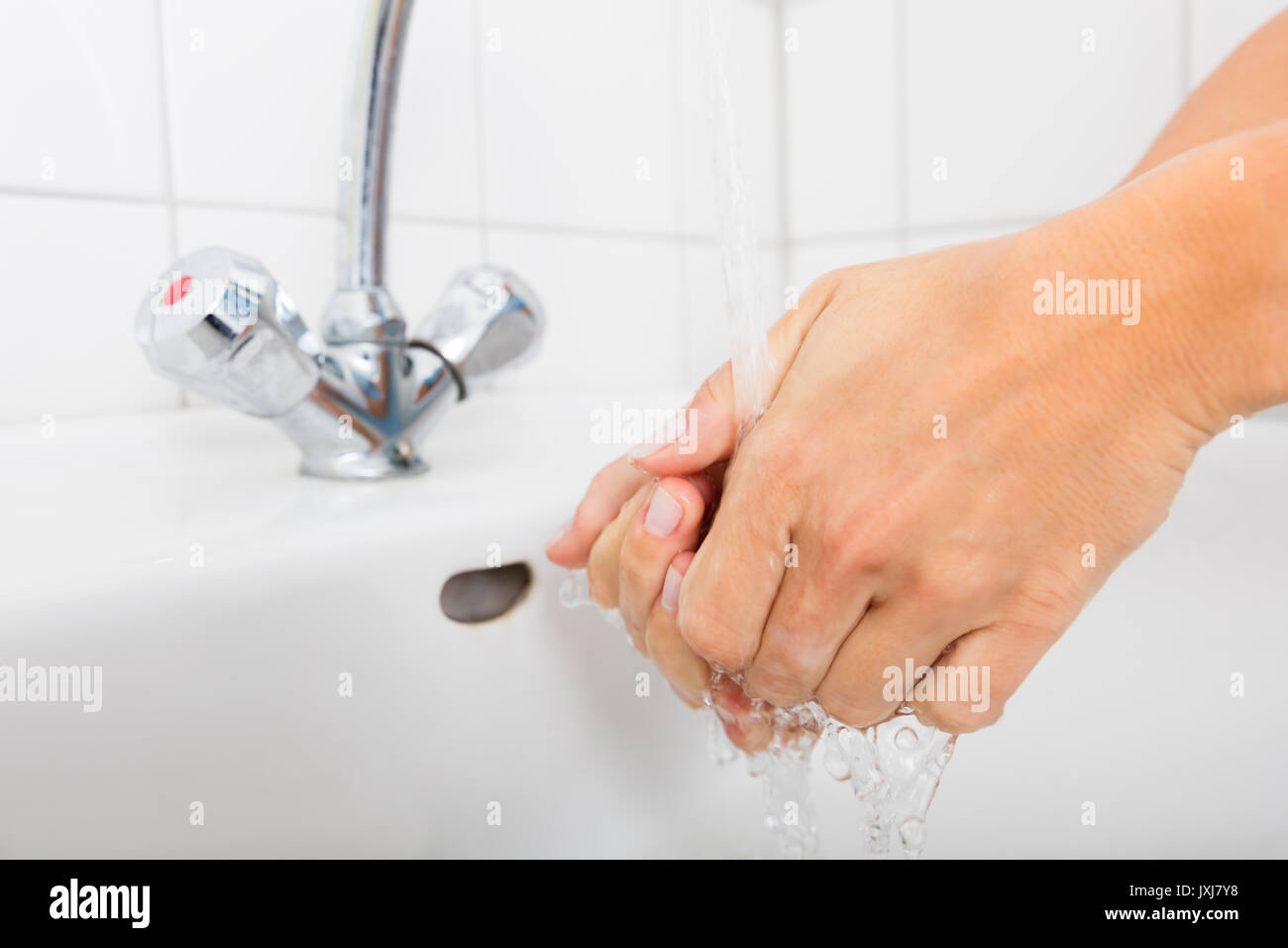 Close-up Of Woman Washing Hands In The Basin After Cleaning The Room Stock Photo