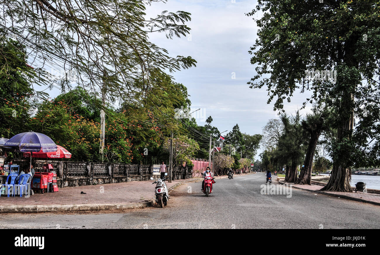 Kampot, Cambodia Dec 31, 2011. People riding scooters on street in