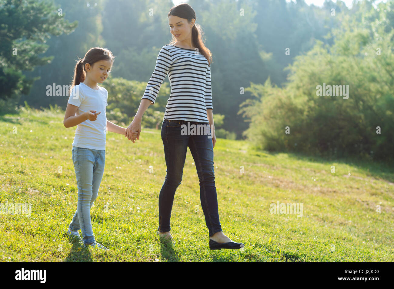 Loving mother and her daughter having a walk in park Stock Photo