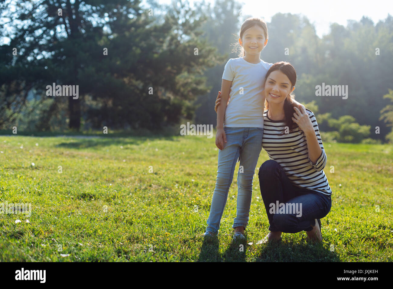 Happy mother and daughter posing in the park Stock Photo