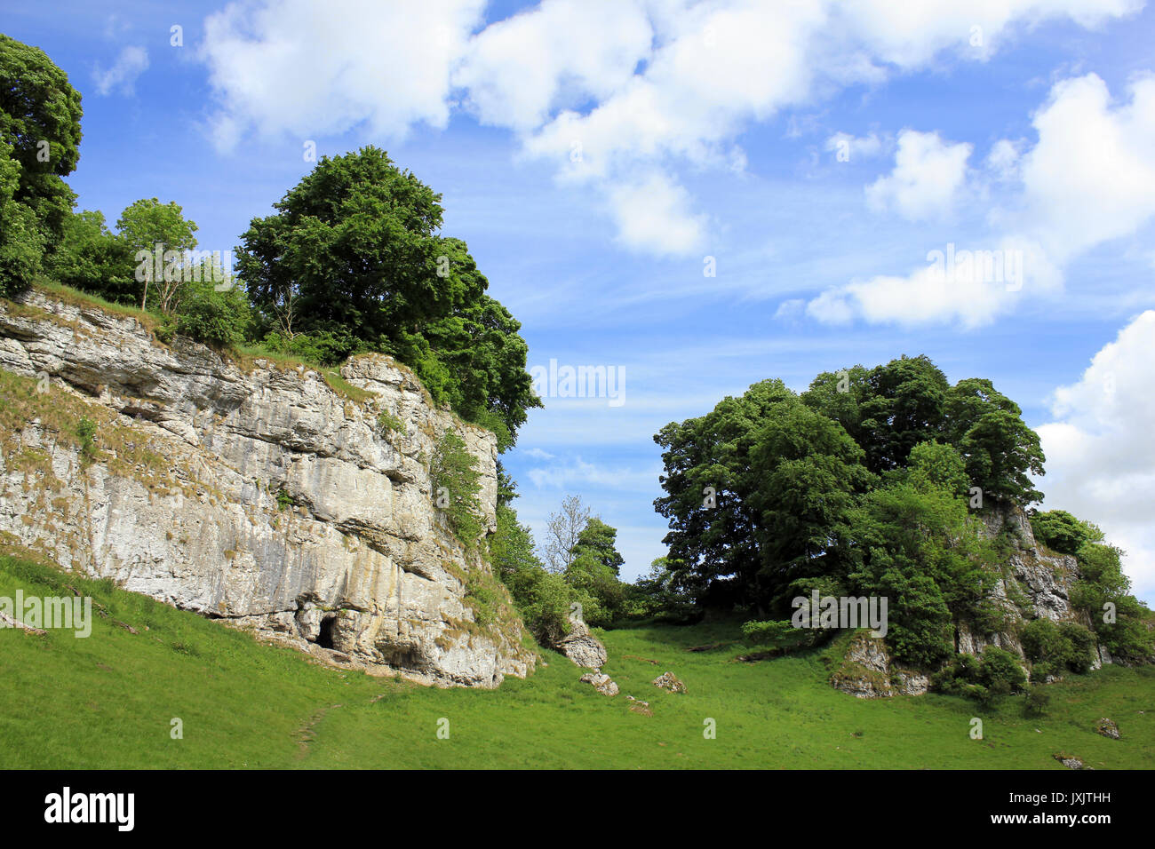 Limestone Outcrop with Frank's Cave (Frank I' Th' Rocks), Wolfscote Dale, Derbyshire, UK Stock Photo