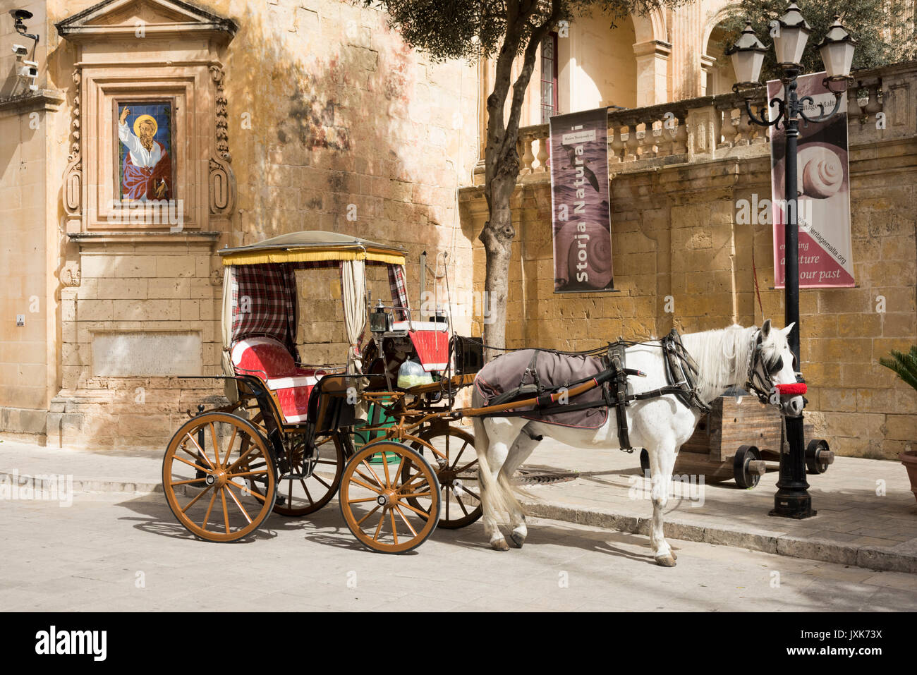 A tourist horse and cart carriage waits for passengers for a trip in Mdina Malta Stock Photo