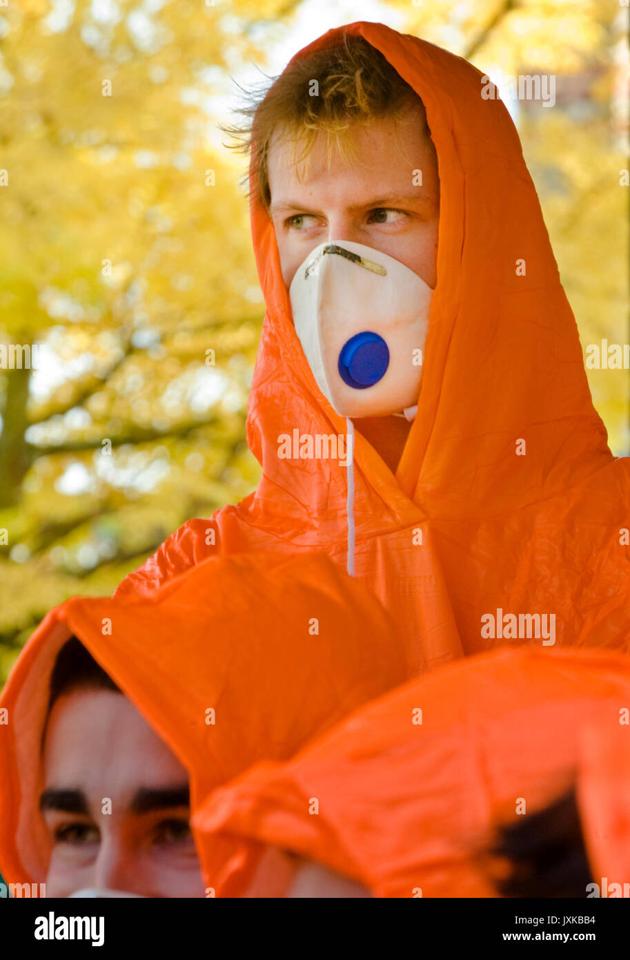 Medical students taking part in a simulated chemical contamination emergency wear brightly coloured coveralls and leave their own clothing in the desi Stock Photo