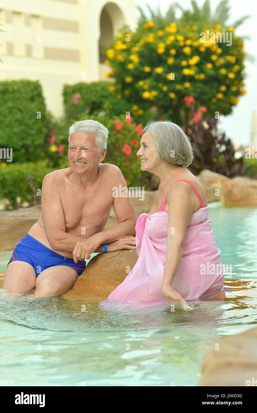 Senior couple relaxing at pool Stock Photo - Alamy
