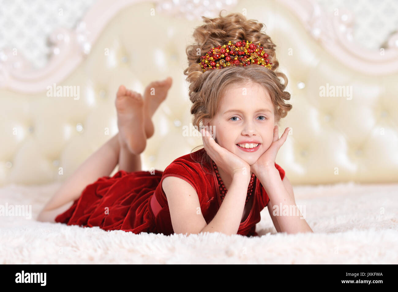 little girl in red velvet dress  Stock Photo