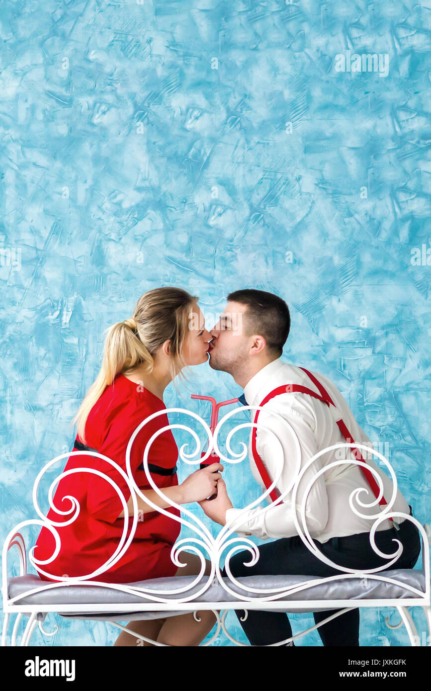 Young couple kissing on bench Stock Photo - Alamy