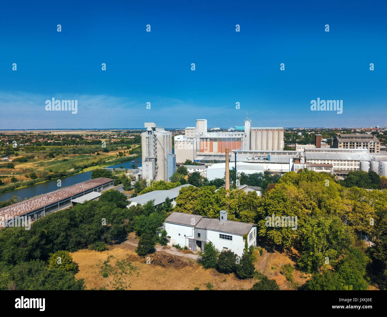 Aerial view of industrial cityscape with factory buildings and warehouses from drone pov Stock Photo