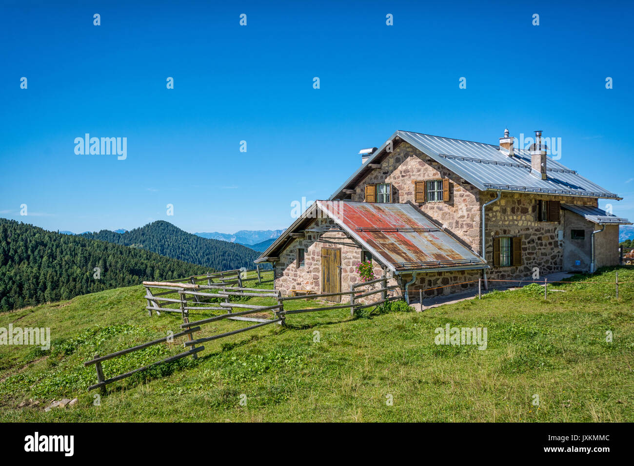 view of alpine mountain scenary with traditional old mountain chalet on a summer day. Dolomites mountains, South Tyrol, Oclini Pass, northern Italy Stock Photo