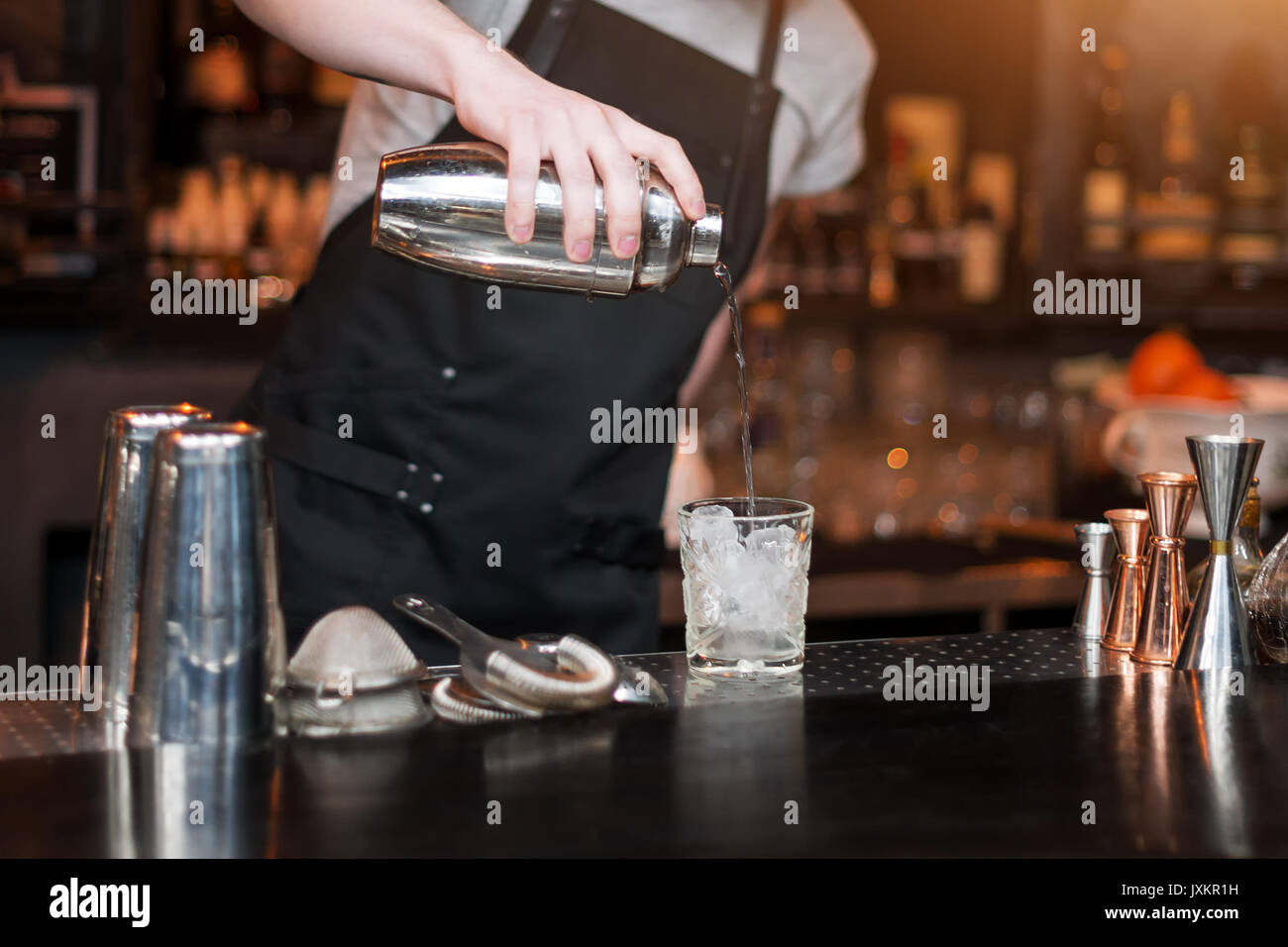 Barman show. Bartender is making cocktail at night club. Stock Photo