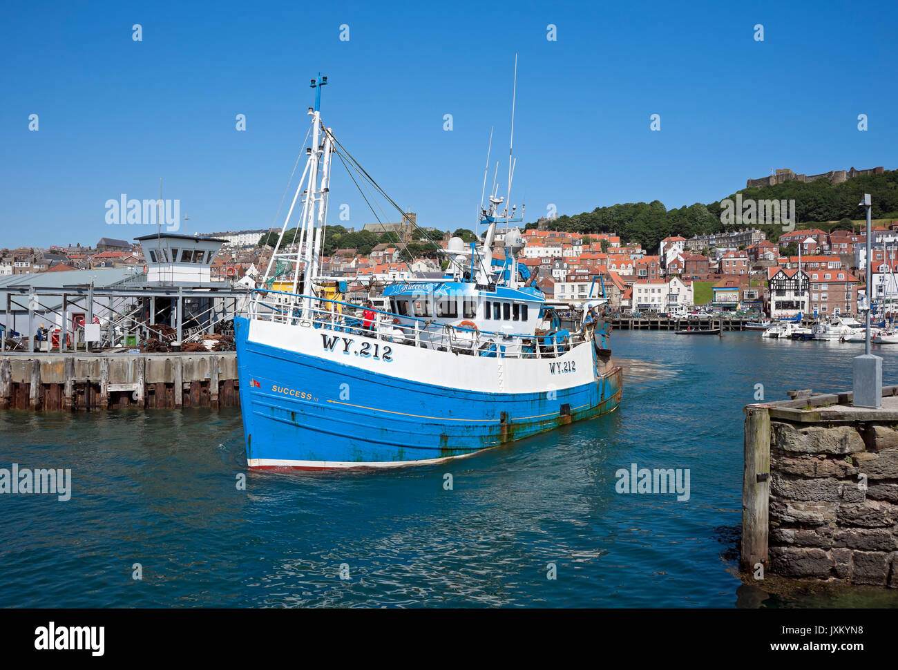 Fishing boat trawler leaving the harbour in summer Scarborough North Yorkshire England UK United Kingdom GB Great Britain Stock Photo